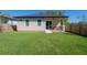 A cozy backyard boasts a well-kept lawn and covered patio, perfect for outdoor enjoyment at 1813 Hillside Dr, Tampa, FL 33610