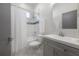 Bathroom featuring tub/shower combo with gray vanity, towel bar, and neutral tiled backsplash at 1813 Hillside Dr, Tampa, FL 33610
