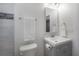 Bright bathroom features a mirrored vanity with a towel bar and toilet at 1813 Hillside Dr, Tampa, FL 33610