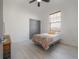 Bedroom features a ceiling fan, neutral hardwood floors, and a window at 1813 Hillside Dr, Tampa, FL 33610