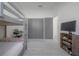 Bright bedroom with bunk beds, a television, and neutral-toned hardwood floors at 1813 Hillside Dr, Tampa, FL 33610