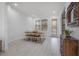 Spacious dining room featuring a table, bench, chairs, and two windows with wood blinds at 1813 Hillside Dr, Tampa, FL 33610