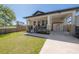 Inviting home featuring a covered front porch, lush lawn, and convenient carport at 1813 Hillside Dr, Tampa, FL 33610