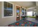 Charming porch featuring comfortable seating, a colorful rug, and a welcoming entrance at 1813 Hillside Dr, Tampa, FL 33610