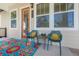 Inviting porch with colorful decor and seating for relaxing and enjoying the outdoors at 1813 Hillside Dr, Tampa, FL 33610