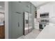 Stylish kitchen boasts stainless steel refrigerator, white countertops, and sleek cabinetry, offering a modern look at 1813 Hillside Dr, Tampa, FL 33610