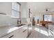 Bright kitchen with white cabinets, stainless steel appliances, and a modern faucet, open to the living room space at 1813 Hillside Dr, Tampa, FL 33610