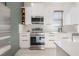 Bright kitchen showcasing white cabinetry, stainless steel appliances, and quartz countertops, creating a clean look at 1813 Hillside Dr, Tampa, FL 33610
