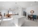 Open-concept living room with modern kitchen, comfortable seating, and light wood flooring at 1813 Hillside Dr, Tampa, FL 33610