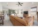 Open-concept living space with a large leather couch, ceiling fan, and views of the kitchen, great flow for entertaining at 1813 Hillside Dr, Tampa, FL 33610