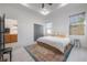 Bright main bedroom with tray ceiling, large windows, and closet at 1813 Hillside Dr, Tampa, FL 33610