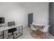 Bright office space with desk, chair, table, and light-colored wood flooring at 1813 Hillside Dr, Tampa, FL 33610