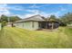 Spacious backyard featuring a screened-in patio with lights, perfect for entertaining and relaxation at 1932 Sean Wood Cir, Brandon, FL 33510