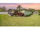 Expansive backyard featuring a screened lanai, mature landscaping, and ample green space at 1932 Sean Wood Cir, Brandon, FL 33510