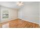 Spacious bedroom boasts wood floors, neutral walls, ceiling fan, and double door closet at 1932 Sean Wood Cir, Brandon, FL 33510