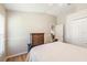 Well-lit bedroom boasts wood floors, neutral walls, and a cozy bed with a decorative headboard at 1932 Sean Wood Cir, Brandon, FL 33510