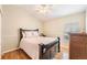 Comfortable bedroom featuring wood floors, ceiling fan, and a cozy bed with decorative pillows at 1932 Sean Wood Cir, Brandon, FL 33510