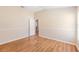 Bright bedroom features wood floors, neutral paint, and an open doorway to an adjacent room at 1932 Sean Wood Cir, Brandon, FL 33510