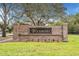 Community entrance sign for 'Woodberry,' featuring a brick facade and lush landscaping at 1932 Sean Wood Cir, Brandon, FL 33510
