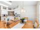 Open concept dining area adjacent to kitchen features wood floors and modern lighting perfect for entertaining at 1932 Sean Wood Cir, Brandon, FL 33510