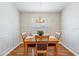 Formal dining area featuring a modern chandelier, wood floors, and decorative wainscoting for an elegant touch at 1932 Sean Wood Cir, Brandon, FL 33510