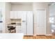 Bright kitchen boasts white cabinets, a side-by-side refrigerator with water dispenser, and a built-in desk area at 1932 Sean Wood Cir, Brandon, FL 33510