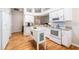 Modern kitchen with white cabinets, an island, stainless steel appliances, and hardwood floors at 1932 Sean Wood Cir, Brandon, FL 33510