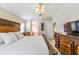 Comfortable main bedroom with elegant wood furniture, ample natural light, and access to ensuite bathroom at 1932 Sean Wood Cir, Brandon, FL 33510