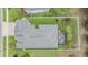 Aerial view of a beautifully landscaped backyard with fenced in patio, manicured lawn, and mature trees at 19608 Lonesome Pine Dr, Land O Lakes, FL 34638