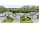 Aerial view of a beautifully landscaped home with a three-car garage, well-manicured lawn, and mature trees at 19608 Lonesome Pine Dr, Land O Lakes, FL 34638