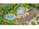 Aerial view of community pool and amenity center surrounded by lush landscaping at 19608 Lonesome Pine Dr, Land O Lakes, FL 34638