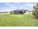 Exterior of home featuring a spacious backyard, screened in patio, and white perimeter fence at 19608 Lonesome Pine Dr, Land O Lakes, FL 34638