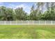 Large, well-manicured backyard featuring a white vinyl perimeter fence for privacy at 19608 Lonesome Pine Dr, Land O Lakes, FL 34638