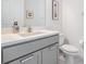 Modern bathroom with gray vanity, white countertop, and updated fixtures at 19608 Lonesome Pine Dr, Land O Lakes, FL 34638
