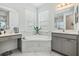 Luxurious bathroom featuring a soaking tub, double vanities and updated fixtures at 19608 Lonesome Pine Dr, Land O Lakes, FL 34638
