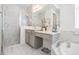 Bright bathroom with marble floors, glass shower enclosure, and vanity with drawers, providing elegant functionality at 19608 Lonesome Pine Dr, Land O Lakes, FL 34638