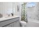 Bright bathroom with white marble, bathtub, and decorative floral shower curtain creates a fresh and airy feel at 19608 Lonesome Pine Dr, Land O Lakes, FL 34638