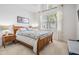 Cozy bedroom with a wooden bed frame, decorative bedding, and bright window at 19608 Lonesome Pine Dr, Land O Lakes, FL 34638