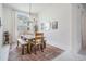 Formal dining room with a decorative rug, a dining table, and an arched window at 19608 Lonesome Pine Dr, Land O Lakes, FL 34638