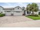 Beautiful home with a three-car garage and a lovely stone-paved driveway at 19608 Lonesome Pine Dr, Land O Lakes, FL 34638