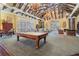 Billiards table in the game room, surrounded by seating areas, offers an inviting space for residents to enjoy recreation at 19608 Lonesome Pine Dr, Land O Lakes, FL 34638