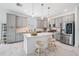 Modern kitchen with stainless steel appliances, gray cabinetry, center island and stylish marble flooring at 19608 Lonesome Pine Dr, Land O Lakes, FL 34638