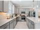 Bright kitchen features stainless steel appliances, granite countertops and tile backsplash at 19608 Lonesome Pine Dr, Land O Lakes, FL 34638