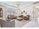 Bright living room featuring tray ceilings, stylish furnishings, and white marble floors at 19608 Lonesome Pine Dr, Land O Lakes, FL 34638