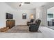 Comfortable living room space with white marble flooring, TV and modern recliners at 19608 Lonesome Pine Dr, Land O Lakes, FL 34638