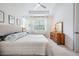 Bright main bedroom featuring tray ceilings, and a large window for ample natural light at 19608 Lonesome Pine Dr, Land O Lakes, FL 34638