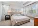Bright main bedroom featuring a large bed, black bedside tables, and lots of natural light at 19608 Lonesome Pine Dr, Land O Lakes, FL 34638