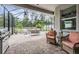 Large screened-in patio with comfortable outdoor seating, lush landscaping, and clear sky, great for relaxing at 19608 Lonesome Pine Dr, Land O Lakes, FL 34638