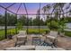 Cozy screened-in patio with comfortable seating, perfect for outdoor relaxation at 19608 Lonesome Pine Dr, Land O Lakes, FL 34638