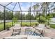Screened patio with brick pavers, outdoor furniture, and beautiful view of the backyard at 19608 Lonesome Pine Dr, Land O Lakes, FL 34638